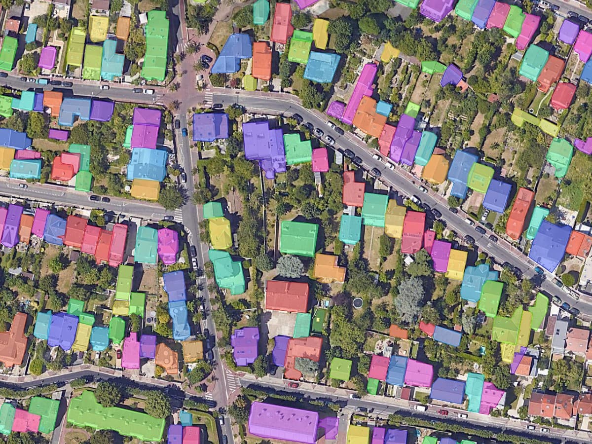 Detached and semi-detached houses in a Paris suburb, each house filled with its own colour