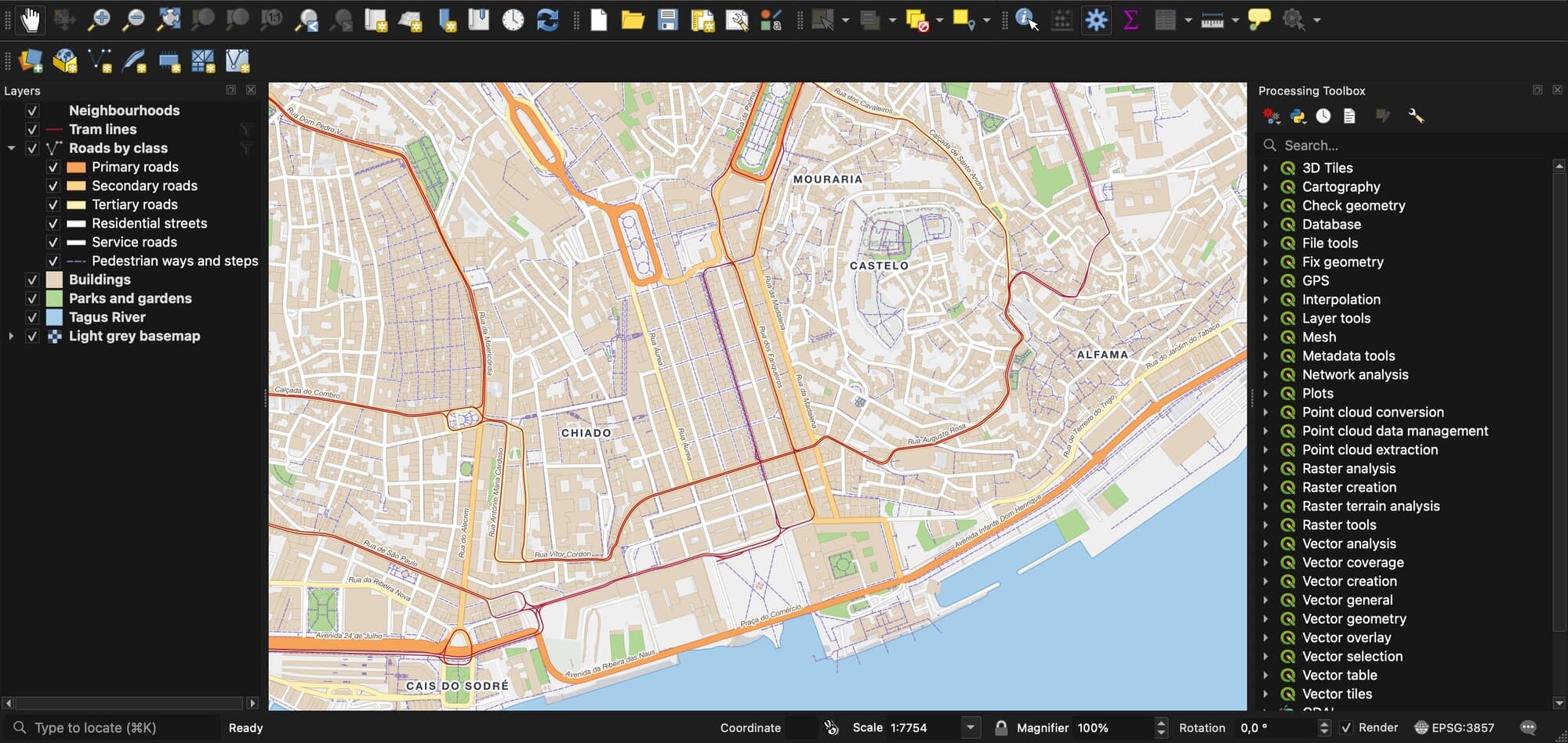 The QGIS 4 main window showing a street map of central Lisbon: buildings in beige, roads coloured by class, red tram lines, parks in green and the Tagus river in blue, with district labels such as Chiado, Castelo, Alfama and Mouraria. The Layers panel on the left lists the layers, and the Processing Toolbox on the right lists tool groups from 3D Tiles to Vector tiles.