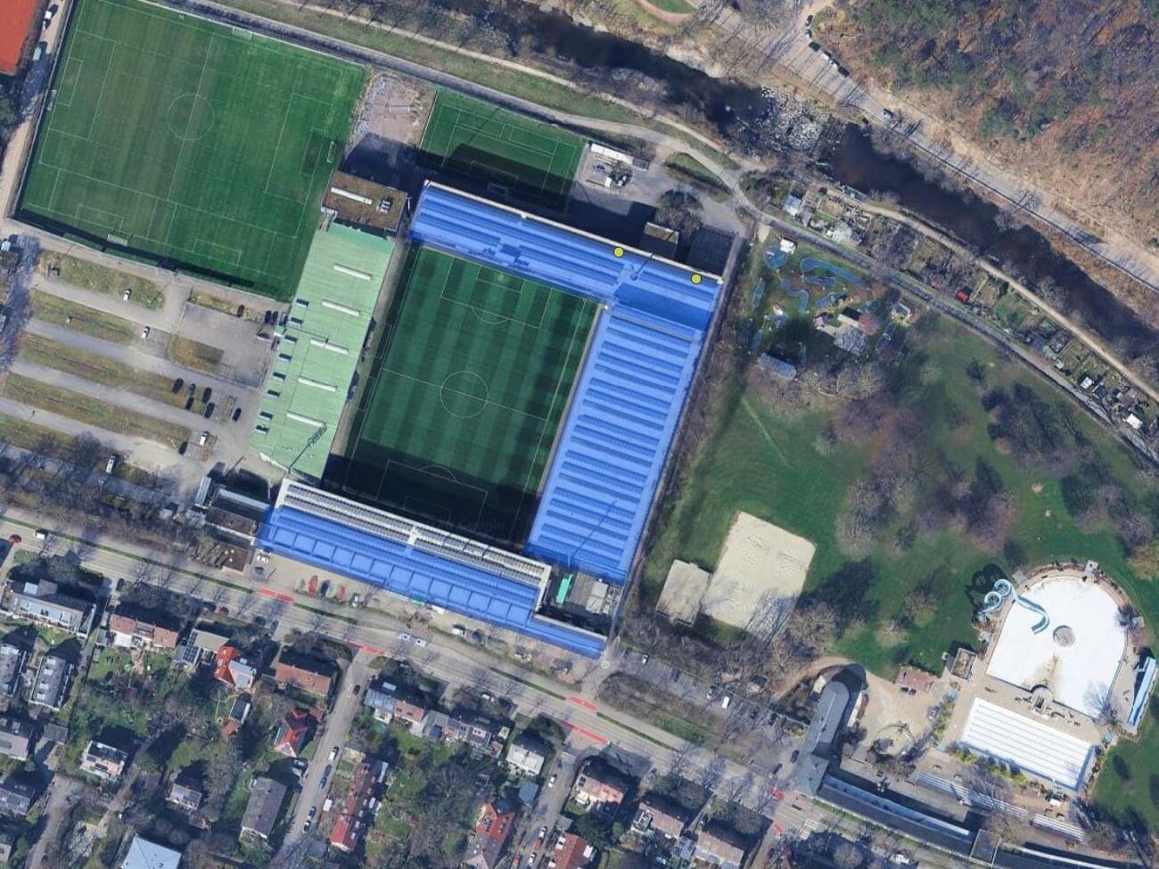 The QuickOSM dialog in QGIS with key generator:source and value solar, and the resulting solar generator polygons drawn over aerial imagery of a small town.