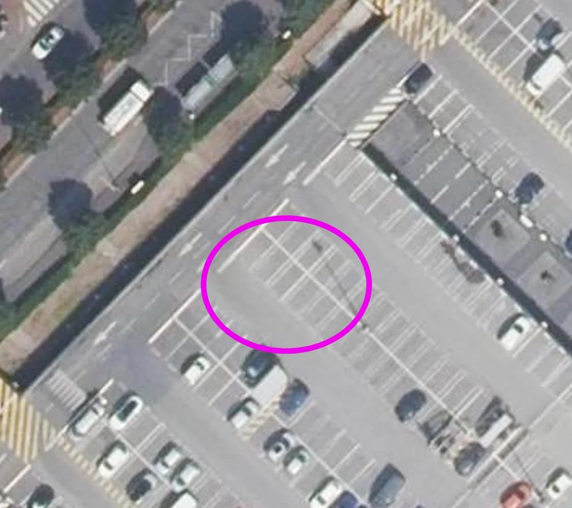 A magenta circle drawn on empty bays of a car park in Montesson