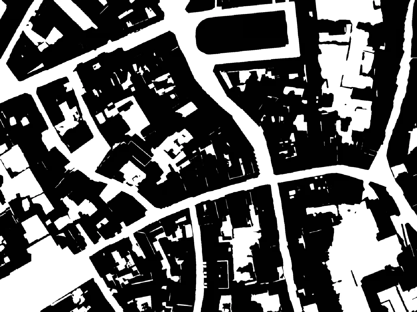 Orthophoto of the old town of Chartres around the covered market on the left, the AI Edit figure ground render of the same frame on the right, buildings in black on white (after)