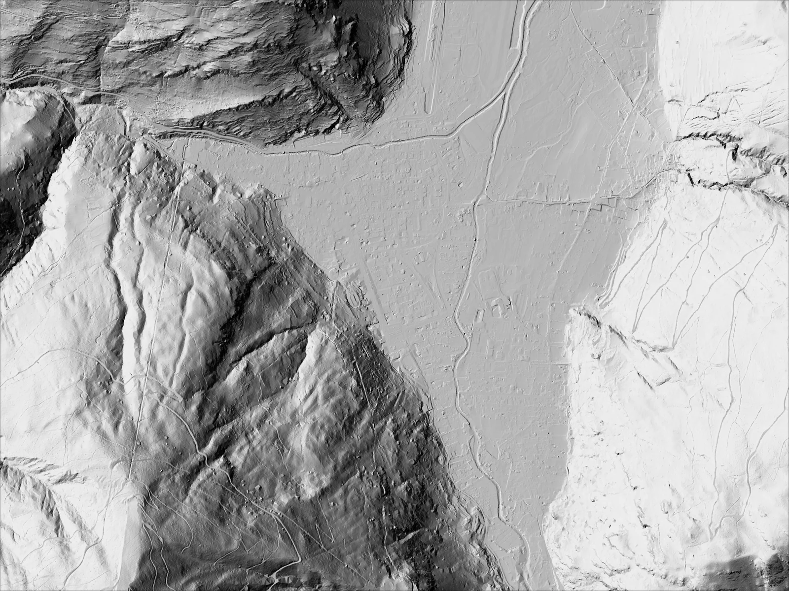 Hillshaded relief of the Pique valley at Bagnères-de-Luchon, France: on one side the 30 m Copernicus DEM shows blurred slopes, on the other IGN's 1 m LiDAR terrain model shows the river, roads, field edges, gullies and the town's street grid. (after)