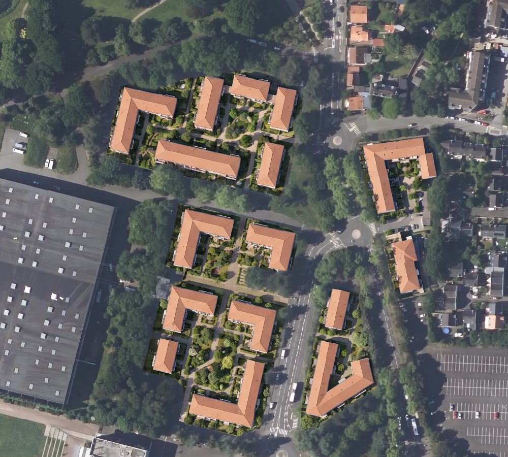 The same aerial view with apartment blocks and courtyards built on the former car parks (after)