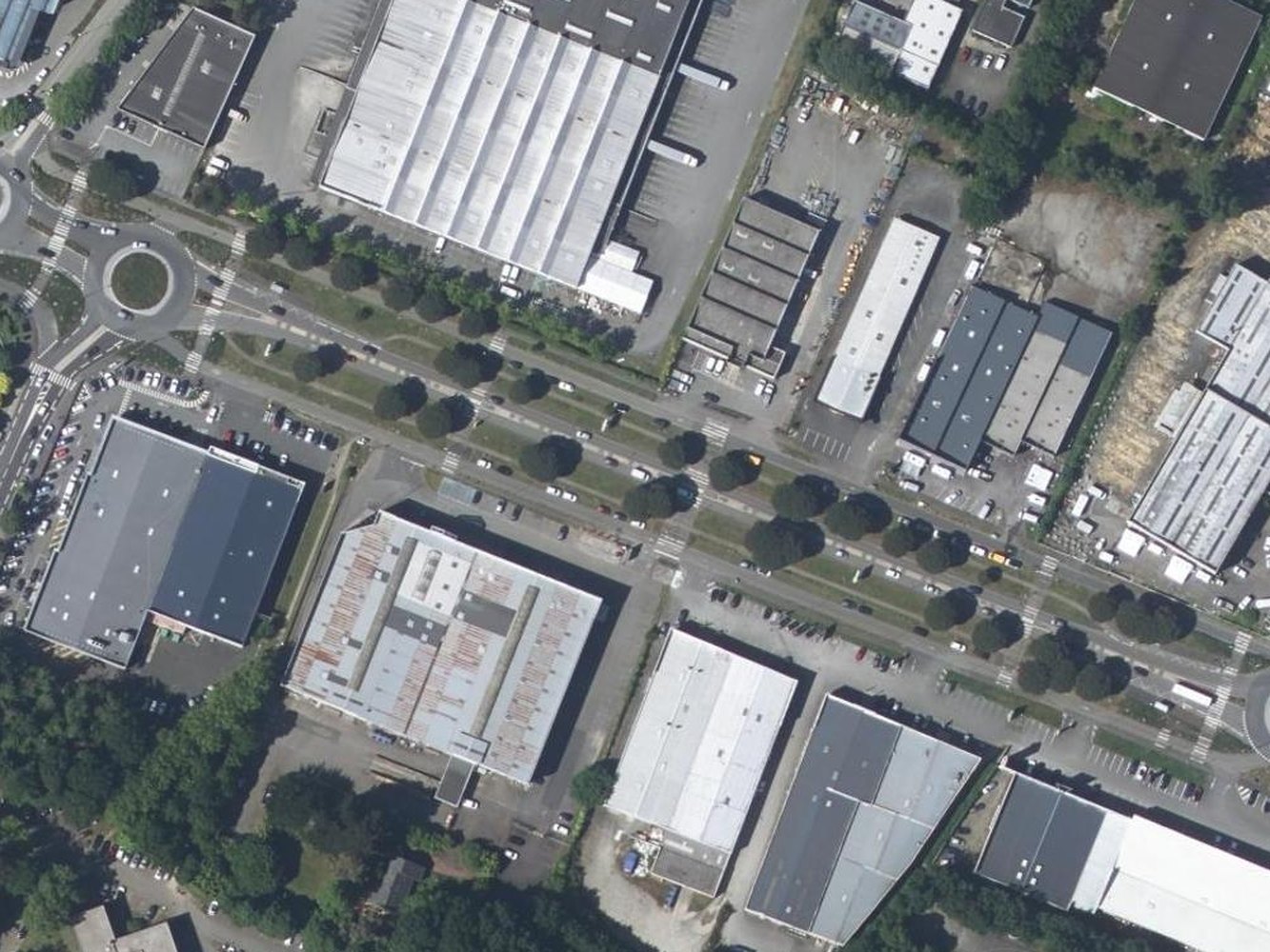 The commercial strip before, then the same view with blue cycle tracks, a red bus lane, a planted central median and rows of new street trees (before)